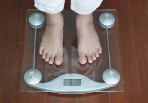 Woman Standing on Digital Weighing Apparatus