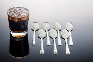 Concept of fizzy cola drinks with unhealthy sugar content